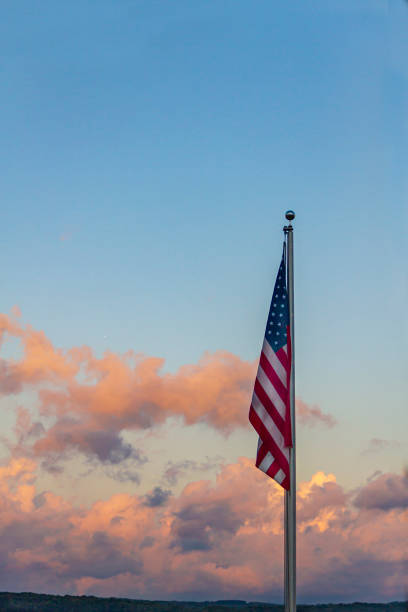 istock USA Flag against Colorful Clouds 1428564534