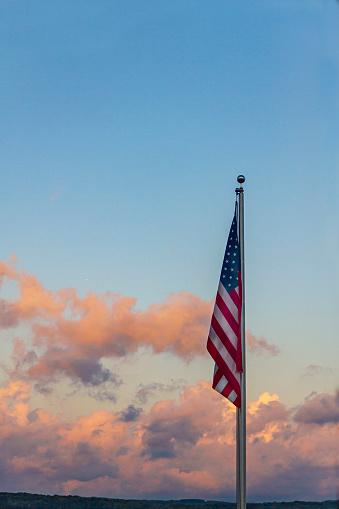 American Flag against Colorful Clouds