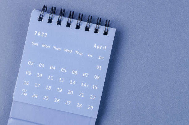 The April 2023 Monthly desk calendar for 2023 year on blue background. stock photo