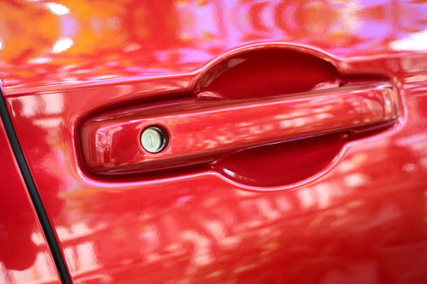 istock door handle of red car, transpotation industry 1428568017