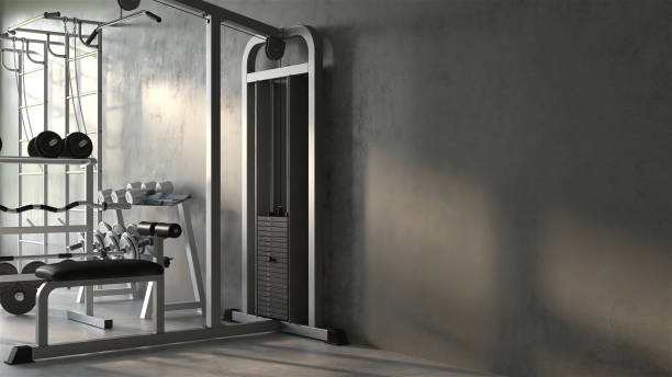 Luxury gym, exercise and sport equipment in modern gray concrete room at home Luxury gym, exercise and sport equipment in modern gray concrete room at home with sunlight from window in background exercise room stock pictures, royalty-free photos & images