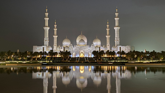 Abu Dhabi, United Arab Emirates – July 18, 2022: Façade of Sheikh Zayed Grand Mosque from Wahat al Karama park.