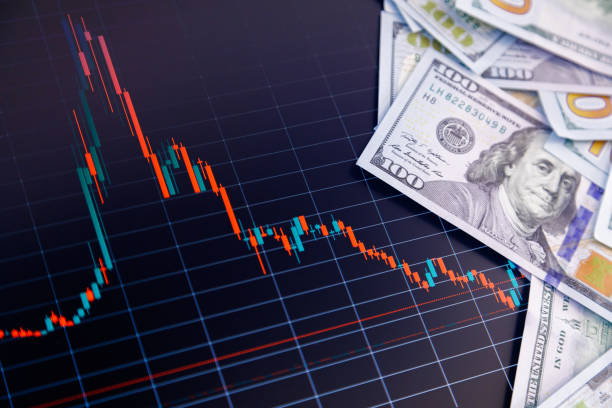 istock US dollar banknote stacks over digital screen with exchange chart, depreciation and volatility concept, close-up perspective view 1428571924