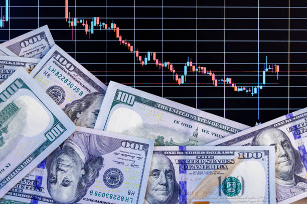 istock US dollar banknote stacks over digital screen with exchange chart, depreciation and volatility concept, directly above view 1428571934