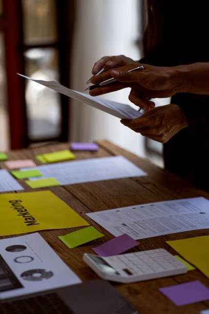 Diverse Startup Teamwork and Integration Ideas: Business Team Coworker Brainstorm Business Ideas Close group discussions with paper on the table plan to work with colleagues in the office.