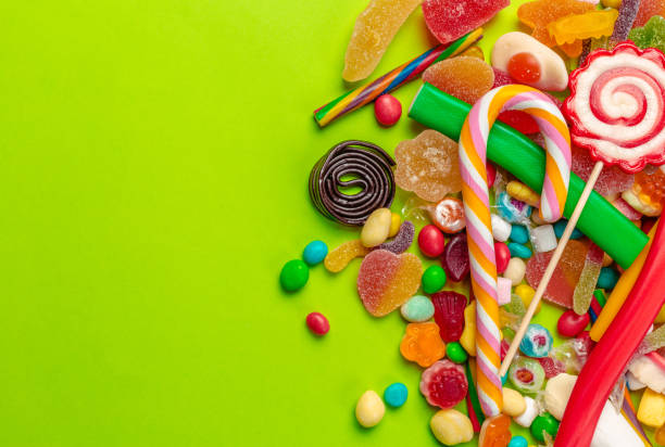 istock Colorful candies on green background 1428593712