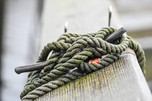 Close up picture of a nautical rope tied to a cleat in Seward, Alaska