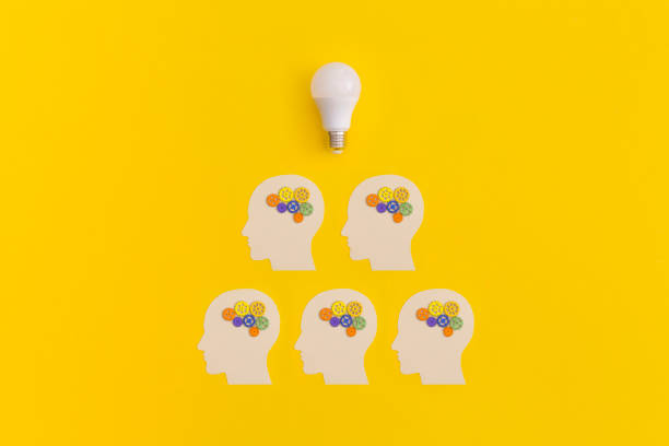 istock Human heads with gears on yellow background. Inspiration and creative idea concept. 1428596867