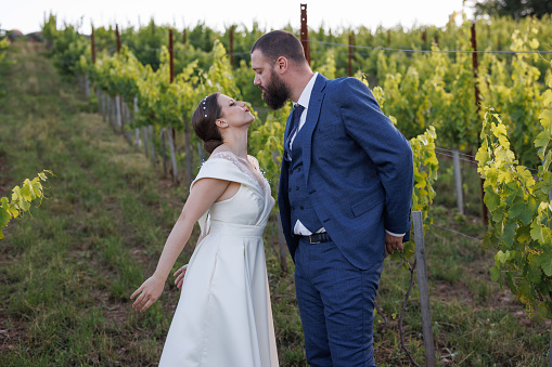 Young couple enjoying in their wedding day surrounded with beautiful vineyard
