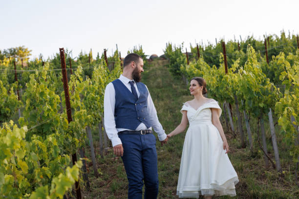 istock Young couple walking through beautiful vineyard on their wedding day 1428600998