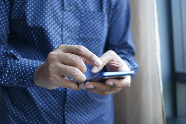 istock Close up of young man hand using smart phone. 1428601912