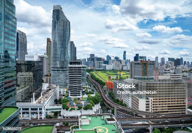 Bangkok Aerial Skyline And Skytrain View Of Thailand Business And Financial Building Area Centers With Smart Green Park Among Urban City At Noon Time Stock Photo - Download Image Now