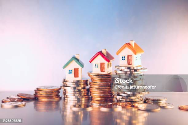 Miniature Colorful House On Stack Coins Stock Photo - Download Image Now - Mortgage Loan, Currency, Finance
