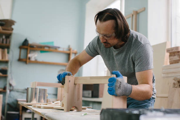istock A carpenter makes children's furniture in a carpentry workshop 1428609397
