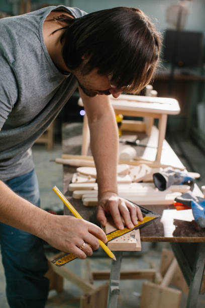 istock Carpenter working with equipment on wooden table in carpentry shop. 1428609465