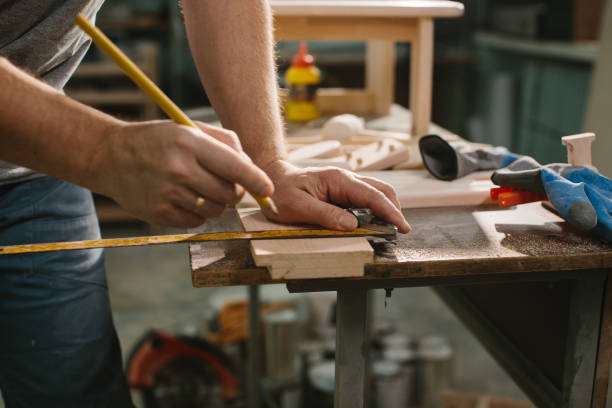 istock Carpenter working with equipment on wooden table in carpentry shop. 1428609471