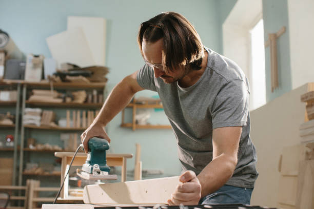 istock Worker grinds the wood of grinding machine. 1428609592