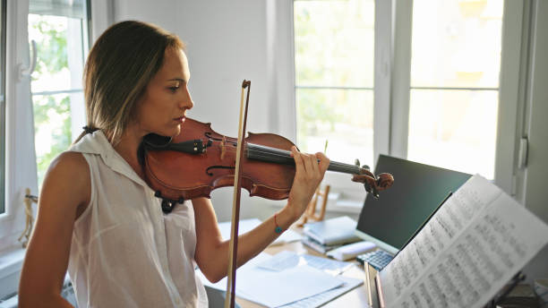 istock Young female violinist practicing at home 1428614786