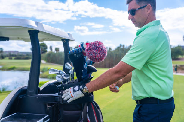 istock Man preparing the golf clubs in the buggy, man playing golf 1428616766