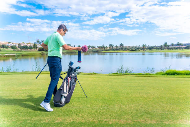 istock Man playing golf at golf club by a lake, driver, iron, pitching 1428617114