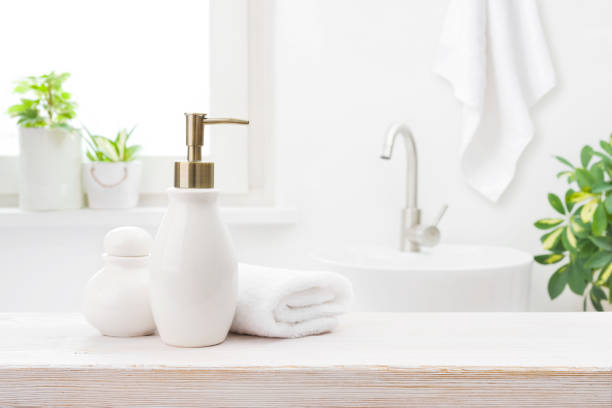 istock Soap dispenser with shampoo and towel on defocused bathroom background 1428623527