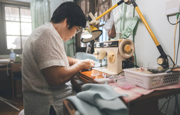 istock Retirement tailor southeast asian elderly crafting a cloth by sewing machine working at home 1428623553