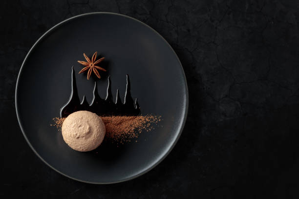 istock Macaroon on a black plate garnished with chocolate sauce and cocoa powder. 1428624870