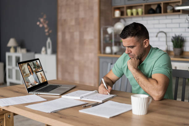 istock Men doing online learning on a laptop while staying at home. 1428625933