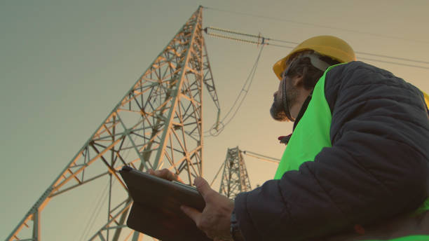 istock High voltage engineer working on the field at night. Sustainable energy. 1428630312