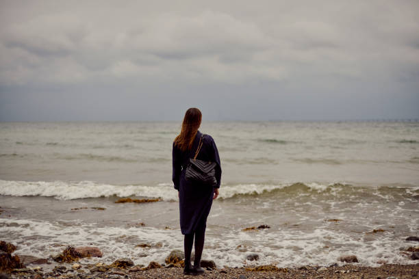 istock Mid adult woman on beach 1428631907