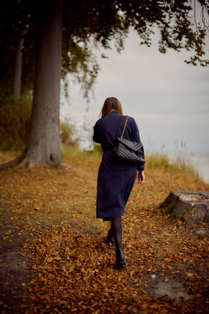 istock Woman walking away in forest 1428632618