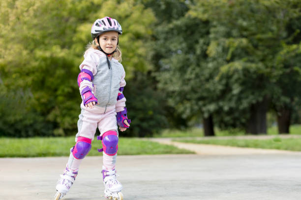 istock Happy young girl wearing protective gear while riding roller skates 1428634236