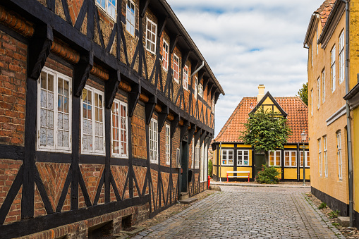 Empty cobbled street and traditional brick houses in Ribe, Denmark. Ribe is located in the Region Syddanmark (english: Region Southern Denmark) and is the oldest town in Denmark.