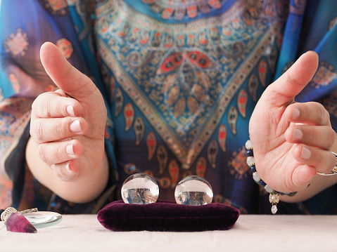 woman fortune telling with crystal