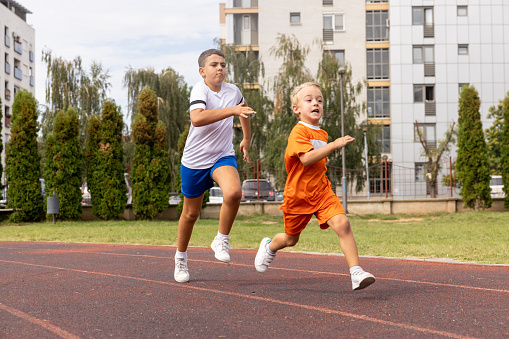 Boys sprinting on the track.