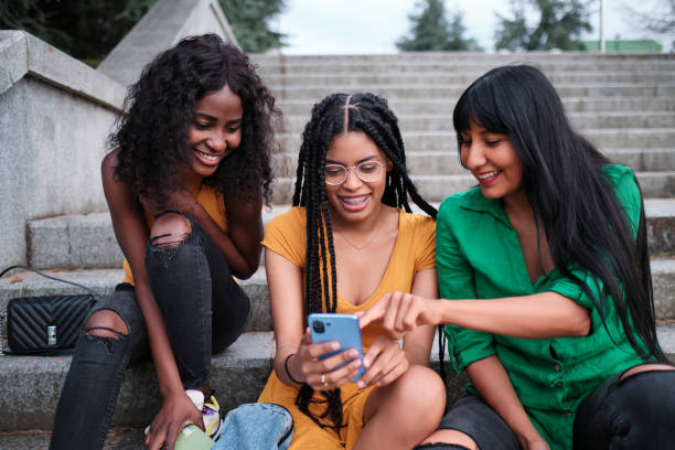 istock A group of friends sitting on a staircase outside using a mobile phone 1428638710