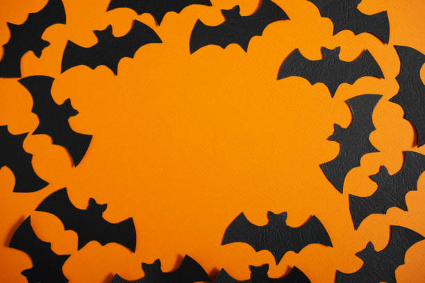 istock Orange background with black bats with space for text. 1428638765