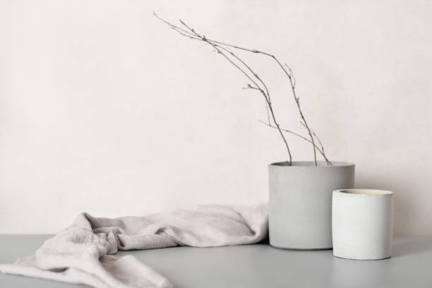 istock fall or winter home decor composition with tree branches in grey cement pot on a gray background. Fall mood still life, Nordic scandinavian minimal style 1428638866