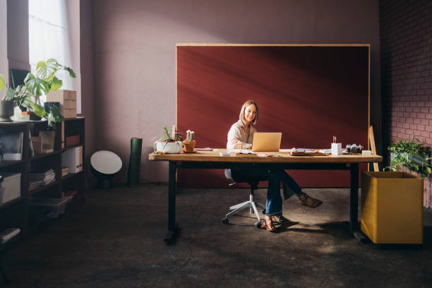 istock A Happy Beautiful Teacher Sitting In The Classroom And Working O 1428639754