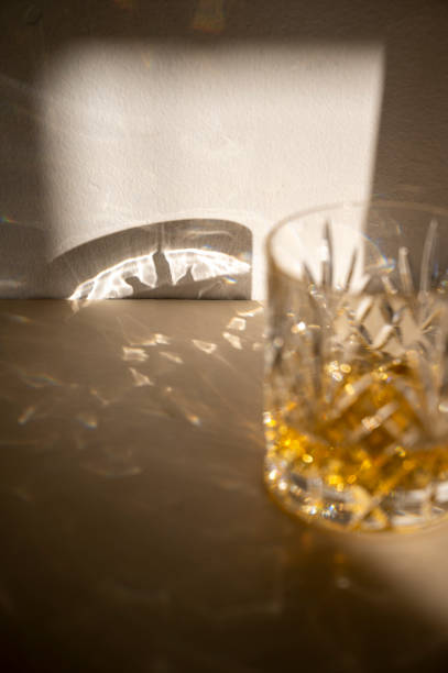 istock Alcohol drink in crystal glasse, sun light, shadows. Brandy or whiskey drink creative natural light. 1428641258
