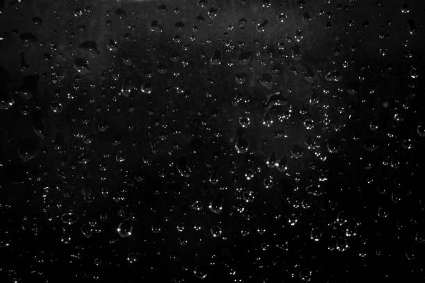 istock drops of water on a dark glass. Abstract background 1428642016