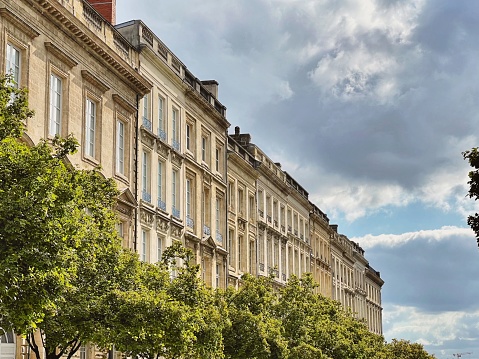View of the rooftops on the tree lined street of Cours du Chapeau Rouge showing the classic French architecture in Bordeaux, Gironde Aquitane, France