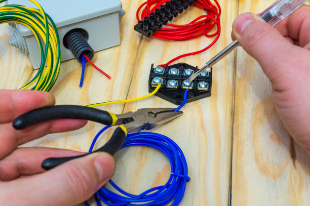 istock The master holds an electric tool and wires to connect 1428645290