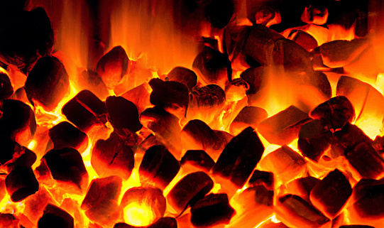 embers in flames background, close up. Pellet