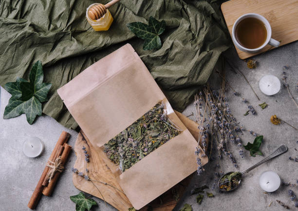Dried and fresh tea leaves with tea, honey and cinnamon stock photo