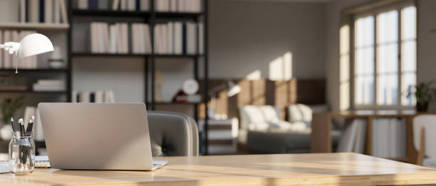 istock Modern workspace tabletop with laptop, stationery and copy space over blurred bedroom background 1428651824