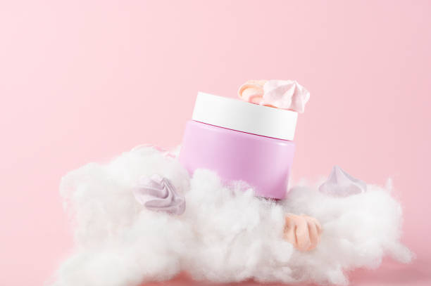 Composition with cosmetic cream jar marshmallows and cotton