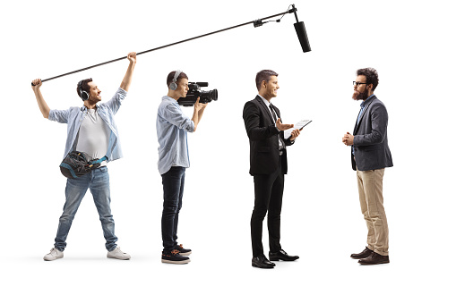 Camera man and sound engineer recording a conversation between men isolated on white background
