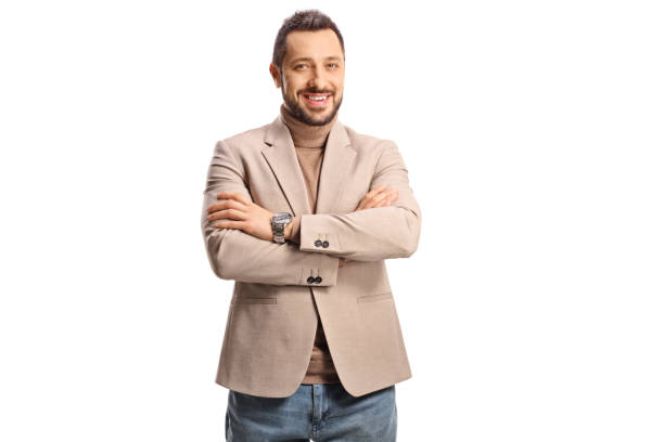 istock Young handsome man in a beige suit and jeans posing and smiling 1428653739