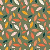 istock Autumn leaf fall on a green background. Seamless cute pattern with leaves or grains in different colors. Vector. 1428659511